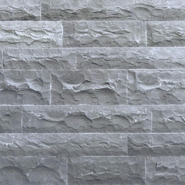 Close-up image for Ankar Gray Basalt - Split Veneer. The surface finish shown is split-face with rough plane. The dominant color shown is gray; with blue and white secondaries. Exhibits "movement" and the color mix creates a cool feeling. Regular and swirled color patterns.