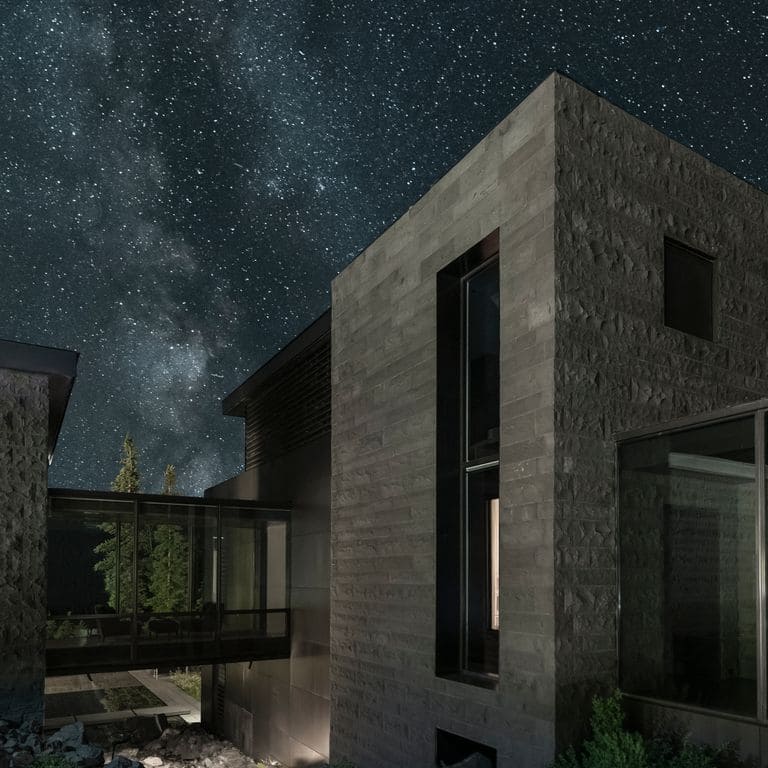 Feature image for Ankar Gray Basalt - Cut to Size Veneer. The image shows this product being used in a full bed veneer application. The surface finish shown is split-face. The dominant color shown is gray; with a brown secondary. The color mix creates a cool feeling. Regular color pattern.