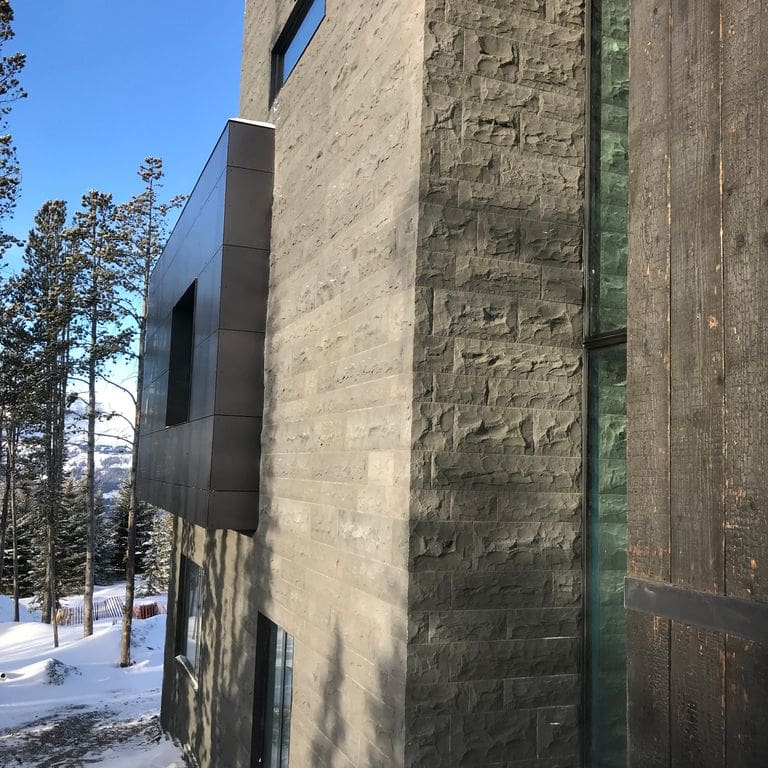 Application image for Basalt - Ankar Gray - Split Veneer. The image shows this product being used in a full bed veneer application. The surface finish shown is split-face. The dominant color shown is gray. Streaked color pattern.