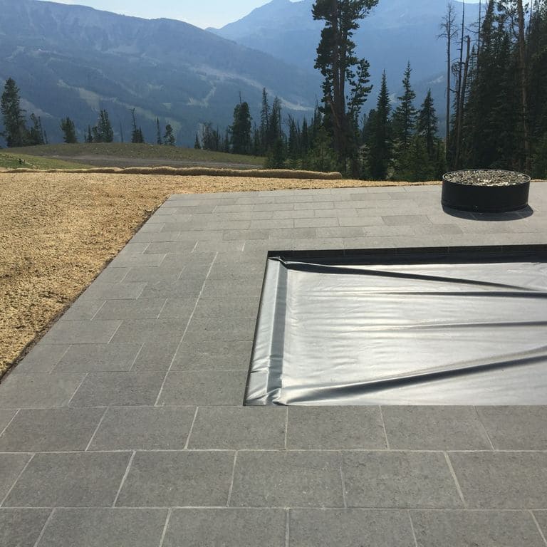 Application image for Nordic Black Basalt - Pavers. The image shows this product being used in a patio pavers application. Dominant colors shown are black and gray.