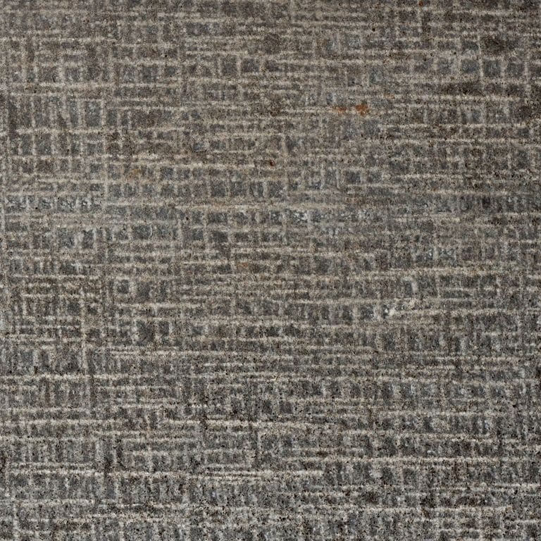 Color/Finish variation image for Ankar Black Basalt - Cobblestones. The surface finish shown is canvas. Dominant colors shown are brown and gray; with green, purple and tan secondaries. The color mix creates a warm feeling. Blotched and linear color patterns.