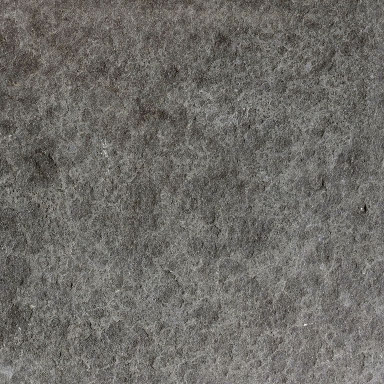 Color/Finish variation image for Ankar Black Basalt - Cobblestones. The surface finishes shown are flamed and waterjet. The dominant color shown is gray; with black, brown, green and purple secondaries. The color mix creates a cool feeling. Blotched and cloudy color patterns.