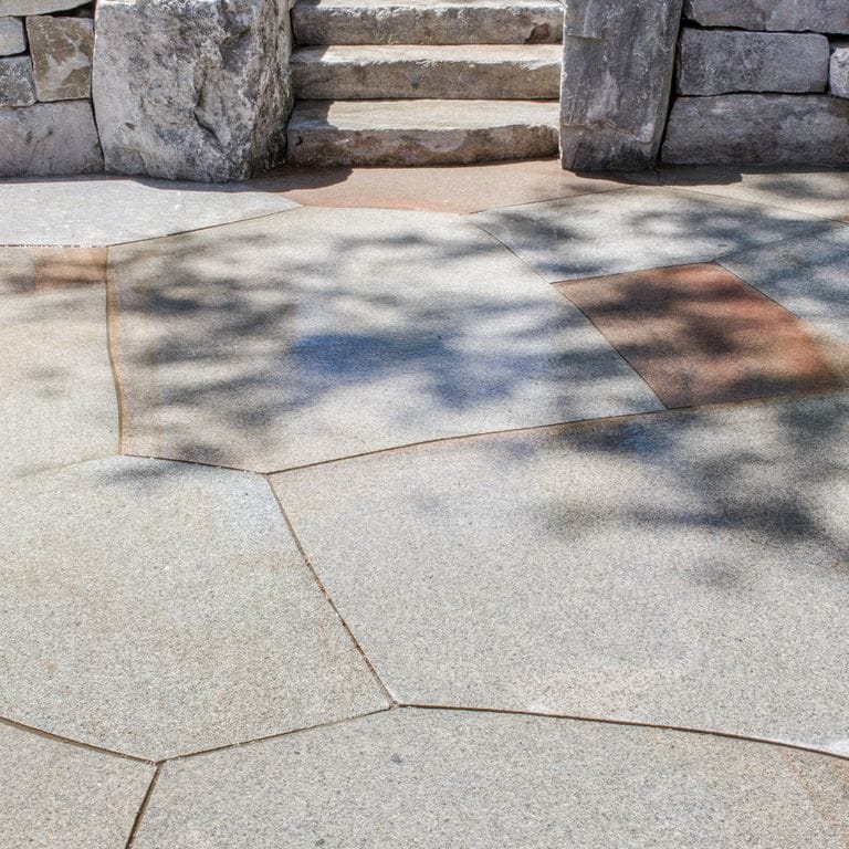 The image shows this product being used in a patio pavers application.