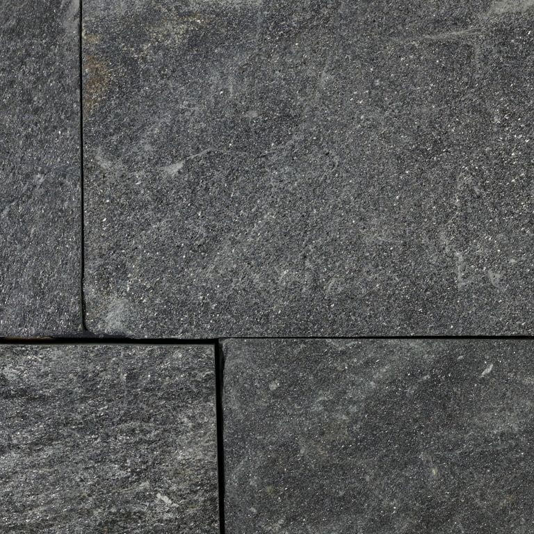 Best close-up image for Raven Hill Granite - Veneer - Seam/Bed Face Split. The image shows this product being used for full bed veneer and thin veneer. The surface finish shown is . Dominant colors shown are black, brown and gray; with green and purple secondaries. Exhibits "movement" and the color mix creates a cool feeling. Fine speckled color pattern. Contains lots of mica and mineral inclusions.