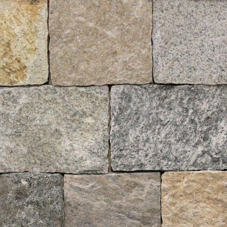 Color/Finish variation image for Connecticut Granite - Veneer Blend. The image shows this product being used for full bed veneer and thin veneer. The surface finish shown is split-face. Dominant colors shown are gray and tan; with beige, brown, green, orange/rust and purple secondaries. Exhibits "movement" and the color mix creates a warm feeling. Swirled, speckled, blotched and cloudy color patterns.
