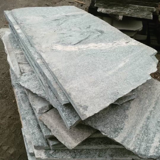 Application image for Granite- Liberty Hill - Veneer. The image shows this product being used for path pavers and patio pavers. The dominant color shown is gray. The color mix creates a cool feeling.