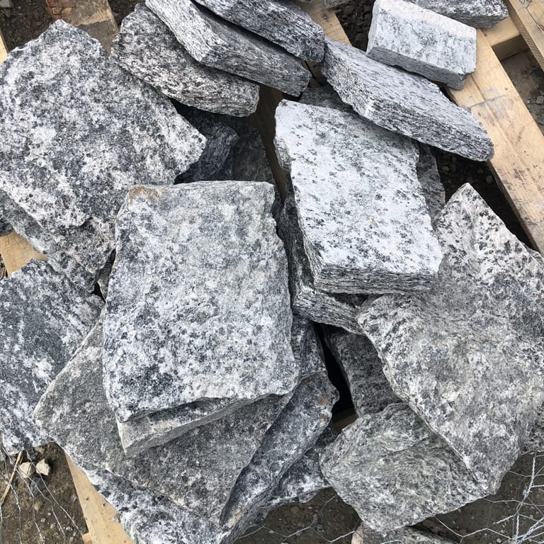 Close-up image for Granite - Greenwich Blue - Veneer. The dominant color shown is gray; with a white secondary. Exhibits "movement" and the color mix creates a cool feeling. Speckled, coarse speckled and blotched color patterns.