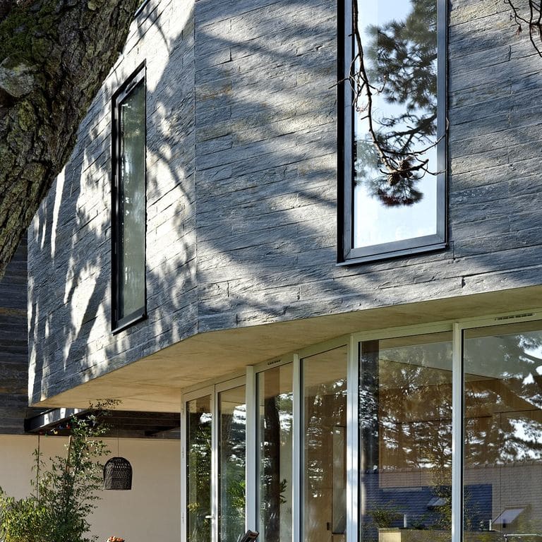 Application image for Black Schist - Wall Veneer. The image shows this product being used for full bed veneer and thin veneer. The surface finish shown is natural cleft. Dominant colors shown are black and gray. The color mix creates a warm feeling.