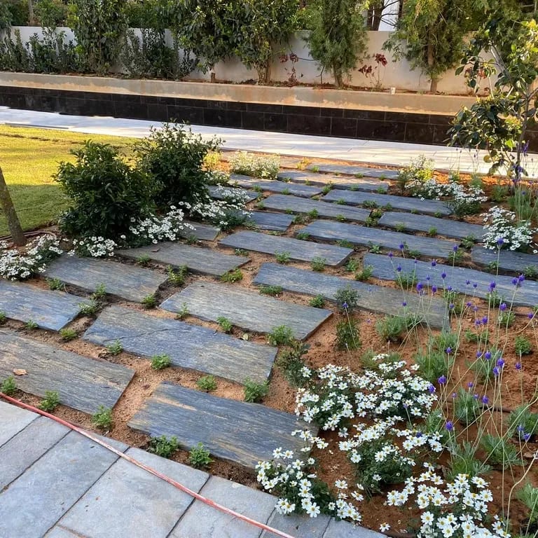 Application image for Black Schist - Pavers. The image shows this product being used in a path pavers application. The surface finish shown is natural cleft. The dominant color shown is gray. The color mix creates a cool feeling.