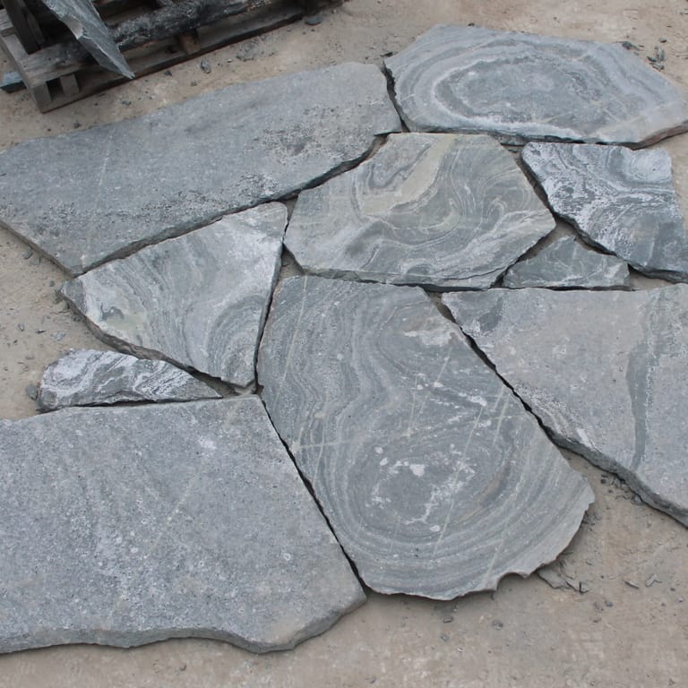 Close-up image for American Mist Granite - Pavers. The surface finish shown is natural. Dominant colors shown are blue and gray. Exhibits "movement" and the color mix creates a cool feeling. Random, speckled, swirled and streaked color patterns.