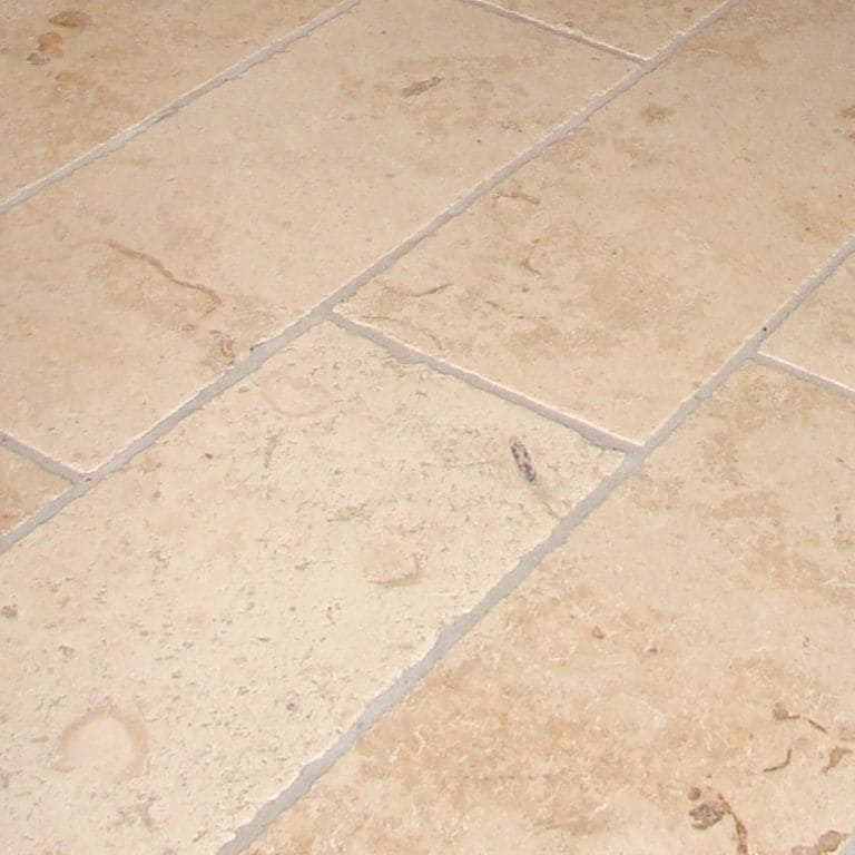 Close-up image for Bavarian Limestone - Beige - Interior Floor. The surface finish shown is honed. Dominant colors shown are beige and tan; with orange/rust, pink and cream secondaries. The color mix creates a warm feeling. Regular, swirled and cloudy color patterns. Contains mineral inclusions.