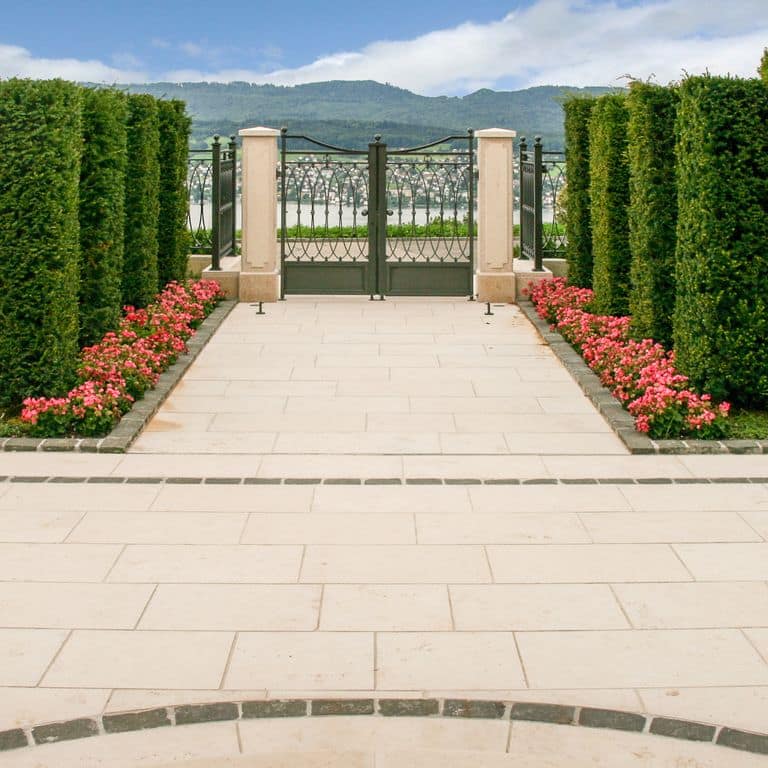 Feature image for Bavarian Limestone Gala - Beige - Pavers. The image shows this product being used in a patio pavers application. Dominant colors shown are beige, tan and cream. The color mix creates a warm feeling. Solid, regular, speckled and cloudy color patterns. Contains mineral inclusions.