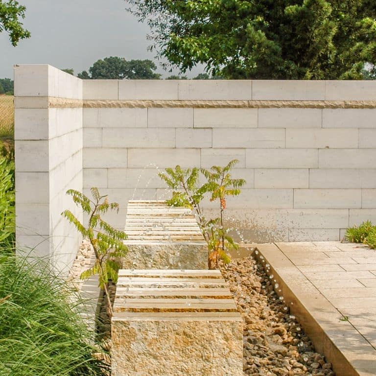 The image shows this product being used in a landscape wallstone application.