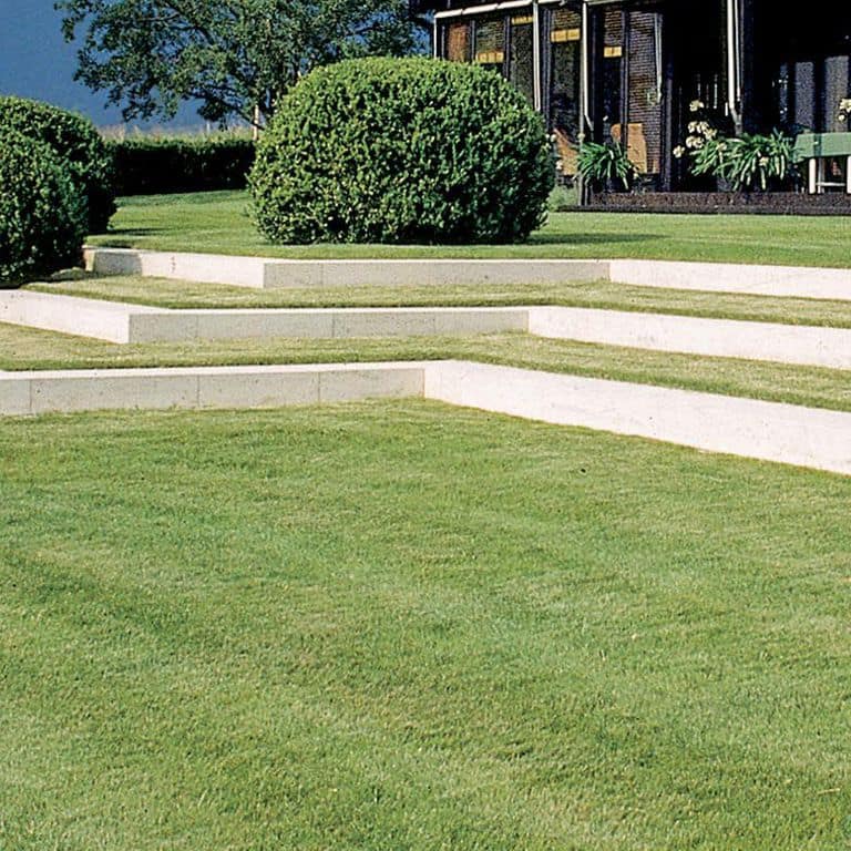 Application image for Bavarian Beige Limestone - Steps &amp; Treads. The image shows this product being used in a monolithic steps application. Dominant colors shown are white and cream; with a beige secondary. The color mix creates a cool feeling. Fine speckled color pattern. Contains mineral inclusions.