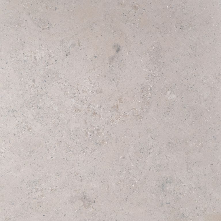 Swatch image cropped for Bavarian Limestone Gala - Beige - Cobblestones. The surface finish shown is honed. The dominant color shown is gray; with beige, pink, purple and white secondaries. Exhibits "movement" and the color mix creates a cool feeling. Cloudy color pattern. Contains mineral inclusions.