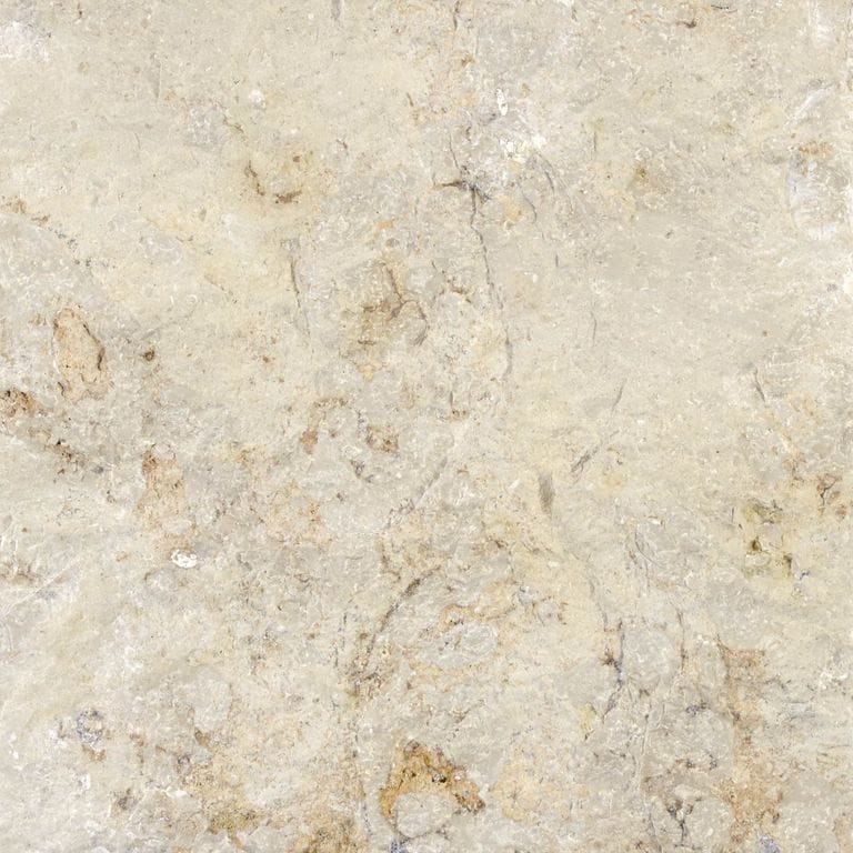 Color/Finish variation image for Bavarian Limestone - Beige - Cobblestones. The surface finish shown is split-face. Dominant colors shown are beige and gray; with blue, pink, purple and white secondaries. The color mix creates a cool feeling. Blotched, random and cloudy color patterns.