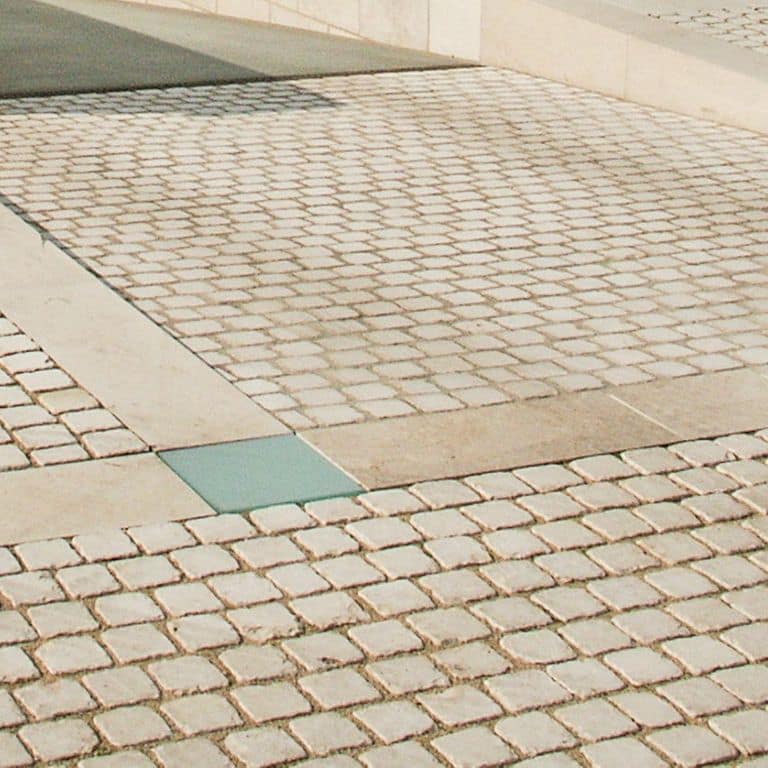 Close-up image for Bavarian Limestone Gala - Beige - Cobblestones. The surface finish shown is antiqued. Dominant colors shown are beige and tan; with gray and cream secondaries. The color mix creates a warm feeling. Solid, regular and cloudy color patterns. Contains mineral inclusions.