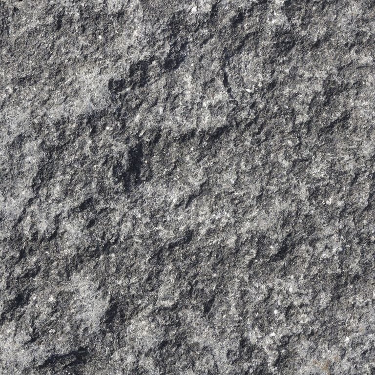 Swatch image cropped for Black Granite Cobblestones - Rectangles. The surface finishes shown are split-face, split-face with flat plane and tumbled. The dominant color shown is gray; with black, brown and green secondaries. Exhibits "movement" and the color mix creates a cool feeling. Regular, blotched and swirled color patterns. Contains some mica.