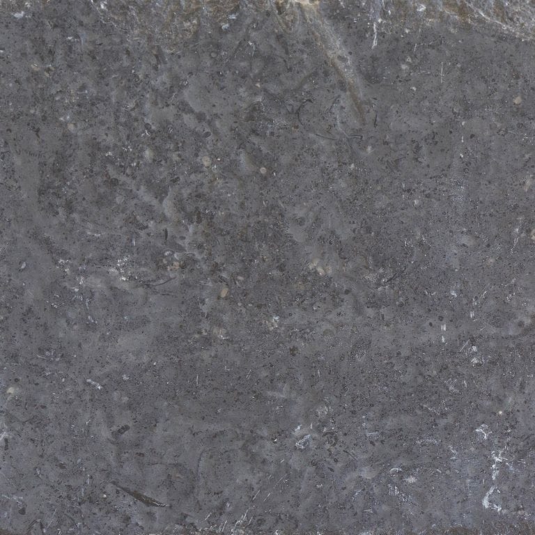 Close-up image for Northern Gray Limestone - Pavers. The surface finishes shown are brushed and flamed. The dominant color shown is gray; with brown and purple secondaries. Exhibits "movement" and the color mix creates a cool feeling. Speckled and swirled color patterns.