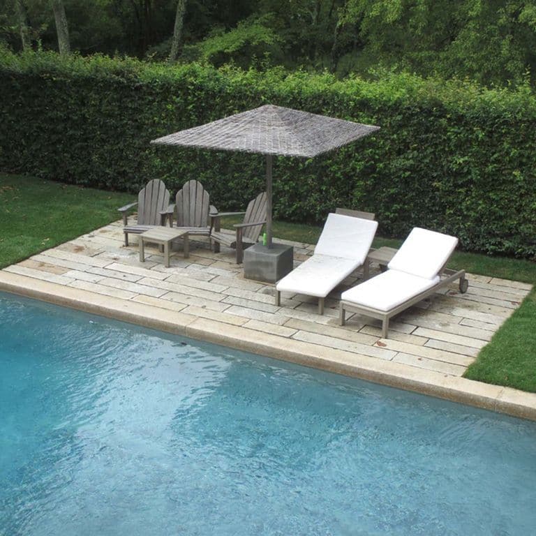 Application image for Reclaimed Footworn Granite - Pool Deck. The image shows this product being used for pool coping and pool deck pavers. Dominant colors shown are beige, gray and tan. The color mix creates a warm feeling.