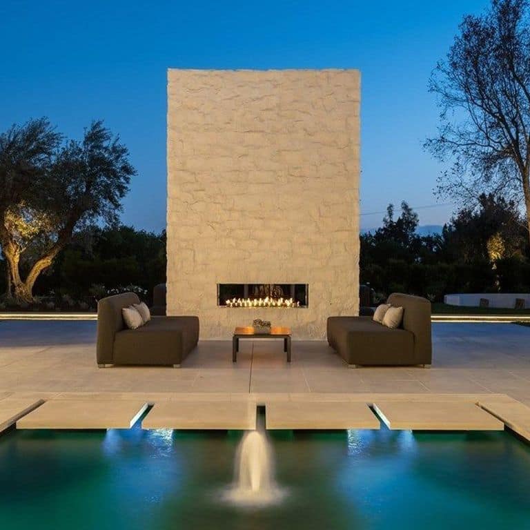 Application image for Limestone- Blanco - Wall Veneer. The image shows this product being used for pool coping, patio pavers, full bed veneer, thin veneer and pool deck pavers. The surface finish shown is flamed. The dominant color shown is tan; with beige and brown secondaries. The color mix creates a warm feeling. Regular color pattern.