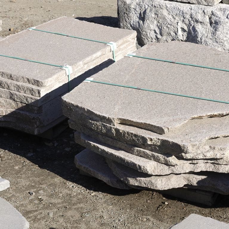 Feature image for Westerly Gray Granite Irregular Pavers. The dominant color shown is gray; with beige, pink, purple, white and cream secondaries. The color mix creates a cool feeling. Fine speckled and veined color patterns. Contains some mica and mineral inclusions.