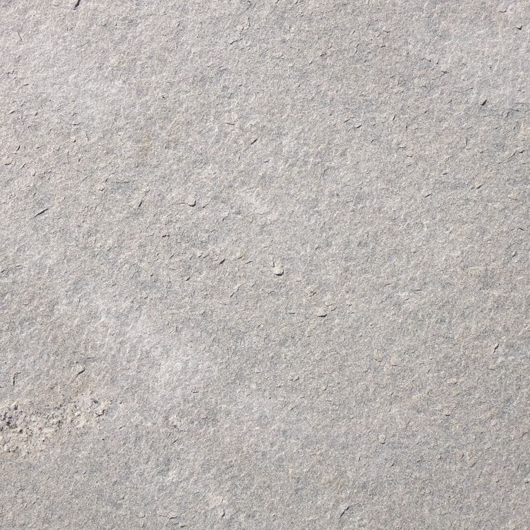 Swatch image cropped for Westerly Gray Granite Irregular Pavers. The surface finish shown is flamed. Dominant colors shown are beige and gray; with pink, purple, white and cream secondaries. The color mix creates a cool feeling. Fine speckled color pattern. Contains some mica and mineral inclusions.