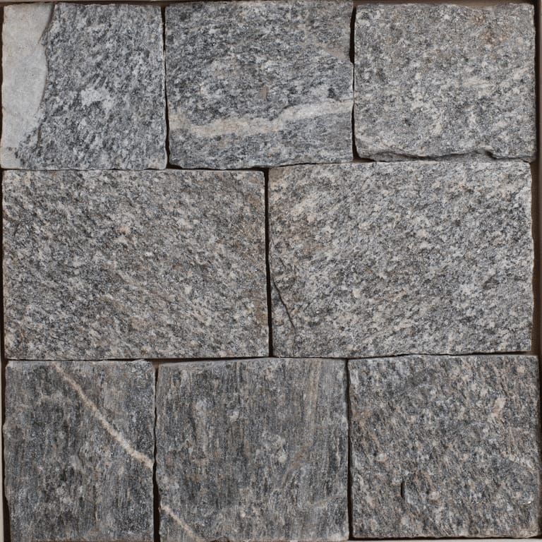 Color/Finish variation image for Bergen Blend Granite - Veneer. The image shows this product being used for full bed veneer and thin veneer. The surface finish shown is split-face. The dominant color shown is gray; with brown, green and purple secondaries. Exhibits "movement" and the color mix creates a cool feeling. Streaked, veined and speckled color patterns.