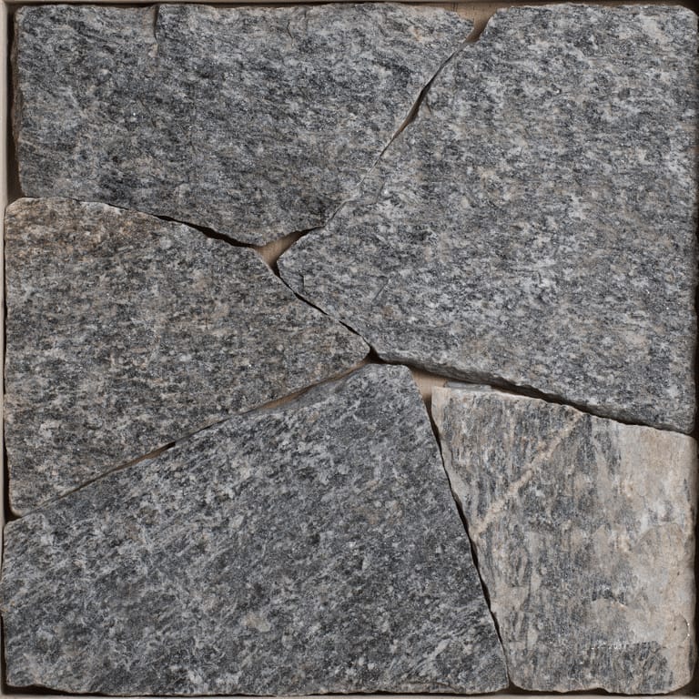 Color/Finish variation image for Bergen Blend Granite - Veneer. The image shows this product being used for full bed veneer and thin veneer. The surface finish shown is split-face. The dominant color shown is gray; with blue, brown and purple secondaries. Exhibits "movement". Veined and speckled color patterns.