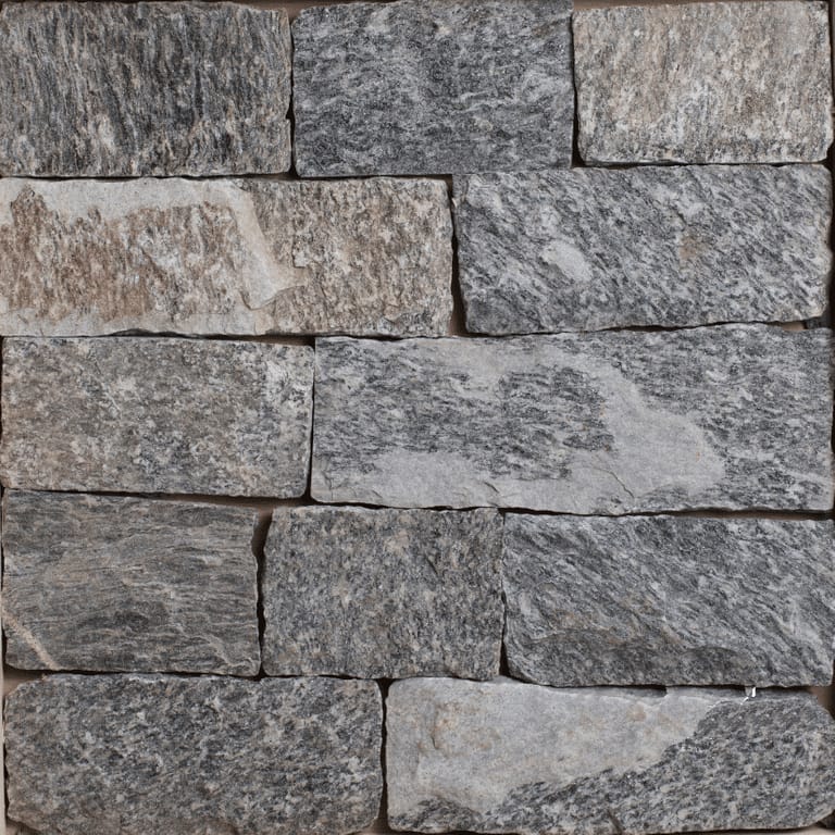Color/Finish variation image for Bergen Blend Granite - Veneer. The image shows this product being used for full bed veneer and thin veneer. The surface finish shown is split-face. The dominant color shown is gray; with blue, brown, purple and white secondaries. Exhibits "movement". Veined and speckled color patterns.