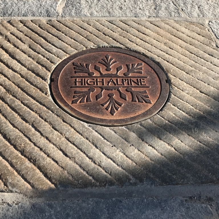 Application image for Reclaimed Granite Manhole Stones. The image shows this product being used in a garden accents application. The surface finish shown is . The dominant color shown is tan. The color mix creates a warm feeling. Regular and fine speckled color patterns.