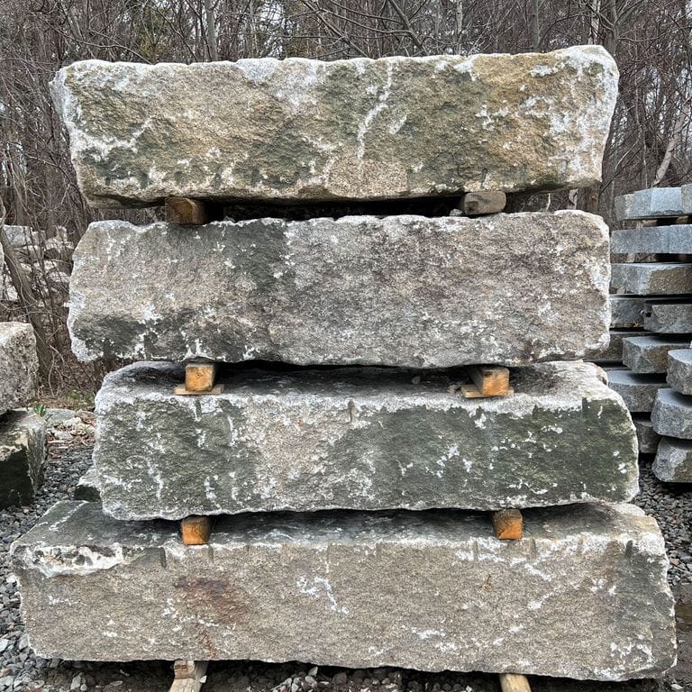Best close-up image for Reclaimed Granite Jetty Stones. The surface finish shown is a combination of split-face, weathered and worn. The dominant color shown is gray; with beige, black, brown, orange/rust, white, tan and cream secondaries. The color mix creates a warm feeling. Speckled color pattern.