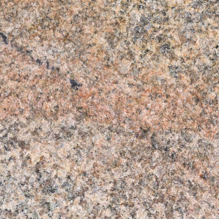 Swatch image for Cape Neddick Full Color Granite - Flamed Top Live Edge Steps. The surface finish shown is flamed. Dominant colors shown are beige, gray, orange/rust and tan; with brown, pink, purple, white and cream secondaries. Exhibits "movement" and the color mix creates a warm feeling. Veined, speckled, blotched and cloudy color patterns.