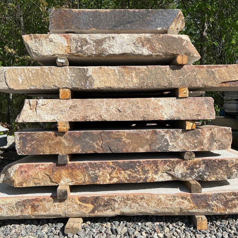 Application image for Granite - Cape Neddick Full Color - Live Edge Steps - Flamed Tops. The surface finish shown is natural. Dominant colors shown are beige, brown and tan; with black, gray, orange/rust and cream secondaries. The color mix creates a warm feeling. Blotched color pattern.