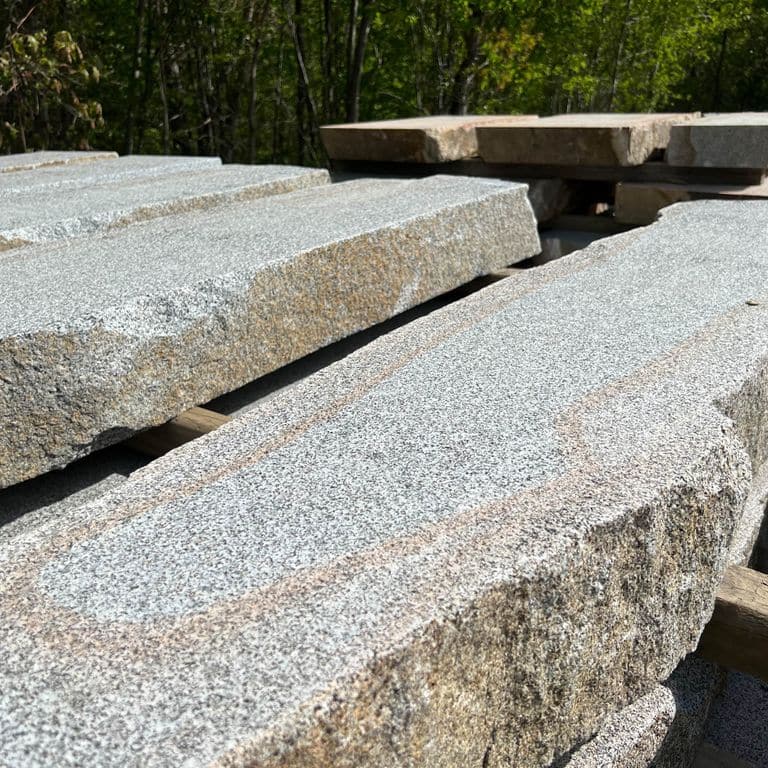 Application image for Dodlin Hill Granite Live Edge Steps - Flamed Tops. The surface finish shown is a combination of flamed and natural. The dominant color shown is gray; with beige, brown, orange/rust, pink, purple, white, tan and cream secondaries. Speckled color pattern.
