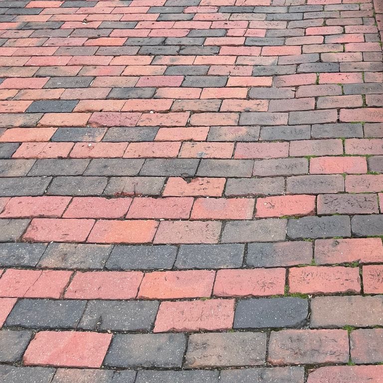 Best close-up image for Brick - Reclaimed Lexington Pavers. The surface finish shown is . Dominant colors shown are orange/rust and red; with brown, orange/rust, pink, purple and tan secondaries. The color mix creates a warm feeling. Regular color pattern.