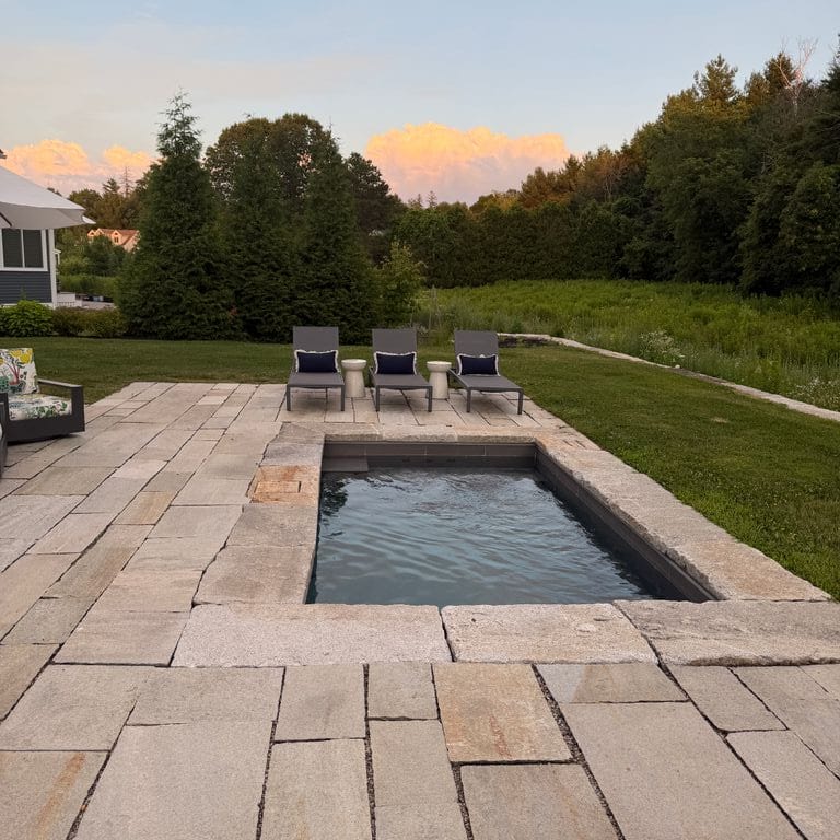 Application image for Pietra Italia Gneiss - Natural Cleft - Pool Deck. The image shows this product being used for patio pavers and pool deck pavers. The surface finish shown is natural cleft. Dominant colors shown are gray and greige. The color mix creates a warm feeling.