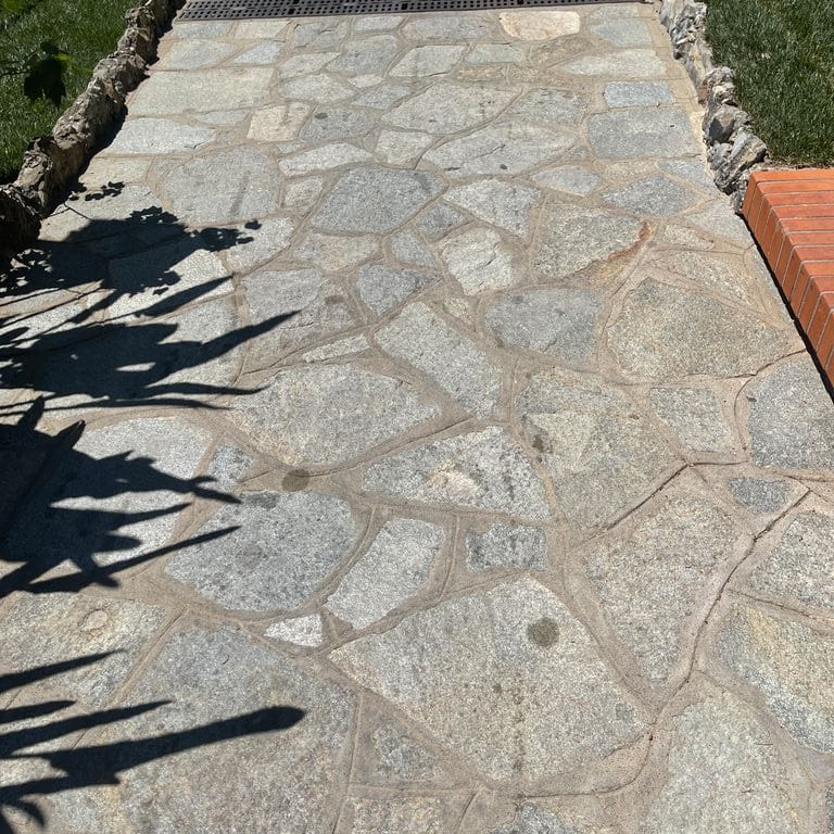 Application image for Pietra Italia Full Color Gneiss - Irregular Pavers. The image shows this product being used in a path pavers application. The surface finish shown is natural cleft. Dominant colors shown are beige and gray. The color mix creates a warm feeling.