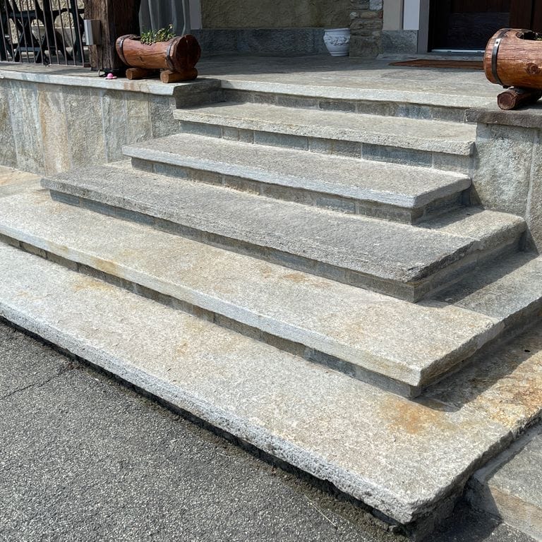 Application image for Pietra Italia Full Color Gneiss - Treads. The image shows this product being used in a treads application. The surface finish shown is natural cleft. Dominant colors shown are gray and tan. The color mix creates a warm feeling.