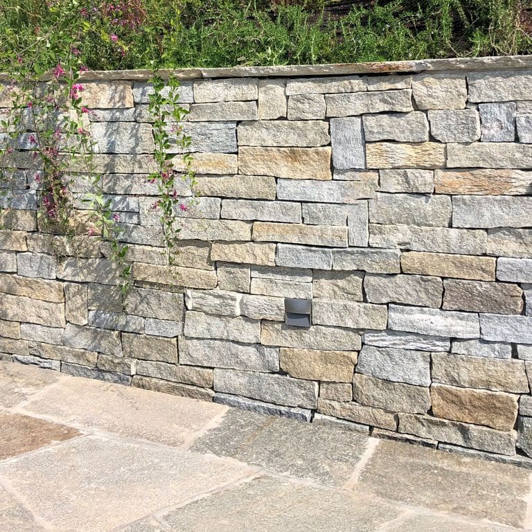 Application image for Pietra Italia Gneiss - Thin Veneer. The image shows this product being used in a thin veneer application. The surface finish shown is natural cleft. Dominant colors shown are gray and tan. The color mix creates a warm feeling.