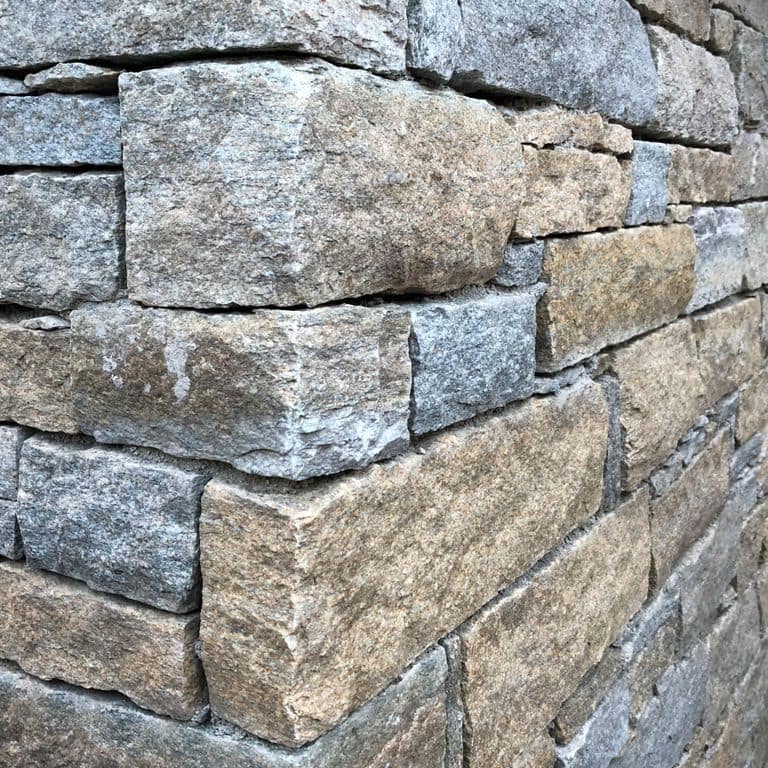 Application image for Pietra Italia Gneiss - Thin Veneer. The image shows this product being used in a thin veneer application. The surface finish shown is natural cleft. Dominant colors shown are gray and tan. The color mix creates a warm feeling.