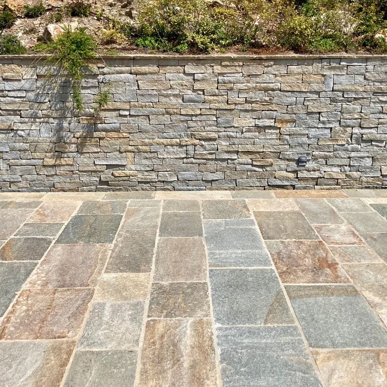 Application image for Pietra Italia Gneiss - Thin Veneer. The image shows this product being used in a thin veneer application. The surface finish shown is natural cleft. Dominant colors shown are gray and tan. The color mix creates a warm feeling.