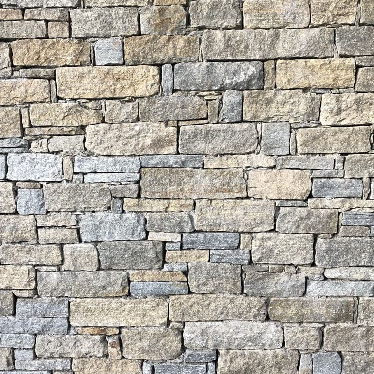 Application image for Pietra Italia Gneiss - Thin Veneer. The image shows this product being used in a thin veneer application. The surface finish shown is natural cleft. Dominant colors shown are gray and tan. The color mix creates a warm feeling.