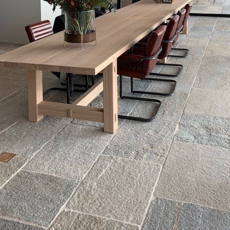 Application image for Pietra Italia Full Color Gneiss - Natural Cleft &amp; Brushed Interior Floor. The image shows this product being used in an interior floor application. The surface finish shown is natural cleft. Dominant colors shown are beige and gray. The color mix creates a warm feeling.