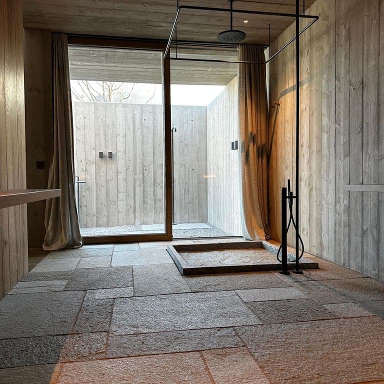 Application image for Pietra Italia Gneiss - Natural Cleft &amp; Brushed Interior Floor. The image shows this product being used in an interior floor application. Dominant colors shown are gray and tan. The color mix creates a warm feeling.