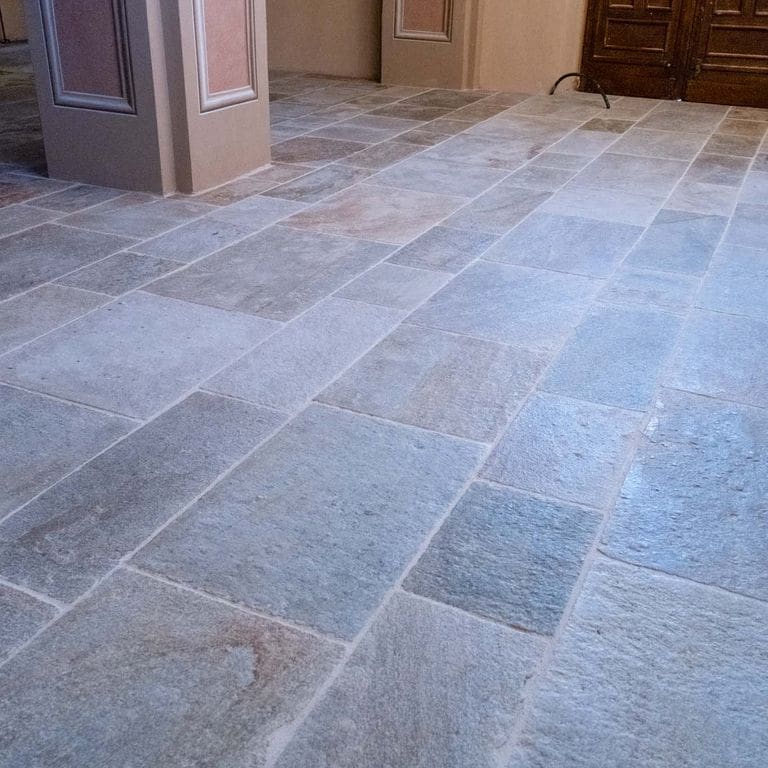 Application image for Pietra Italia Gneiss - Natural Cleft &amp; Brushed Interior Floor. The image shows this product being used in an interior floor application. Dominant colors shown are gray and tan. The color mix creates a warm feeling.