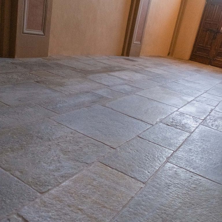 Application image for Pietra Italia Gneiss - Natural Cleft &amp; Brushed Interior Floor. The image shows this product being used in an interior floor application. Dominant colors shown are gray and tan. The color mix creates a warm feeling.