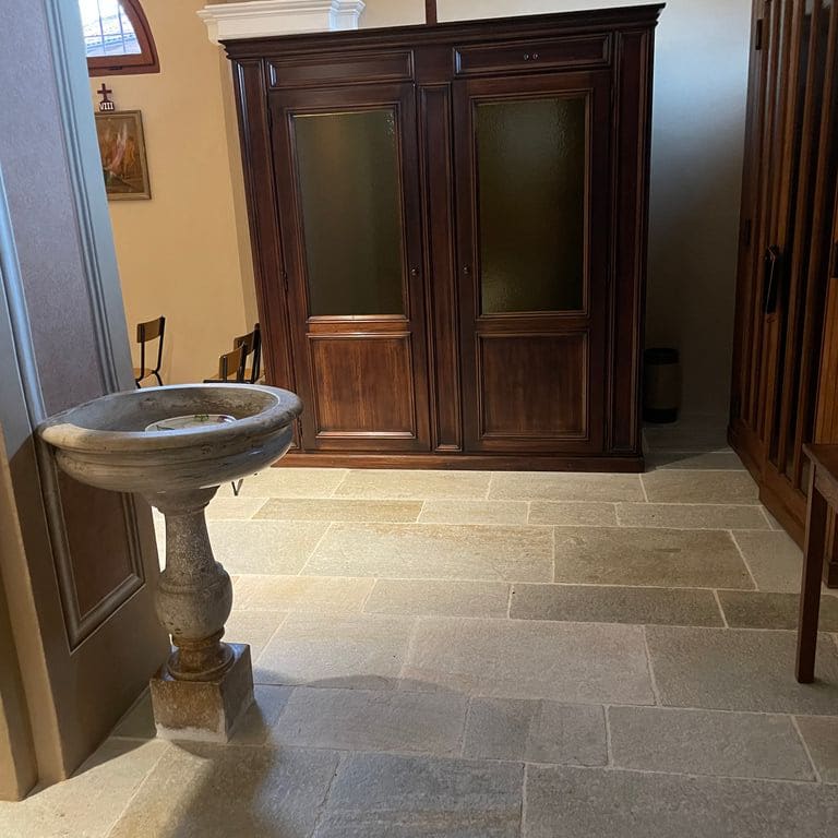 Application image for Pietra Italia Gneiss - Interior Floor. The image shows this product being used in an interior floor application. Dominant colors shown are gray and tan. The color mix creates a warm feeling.