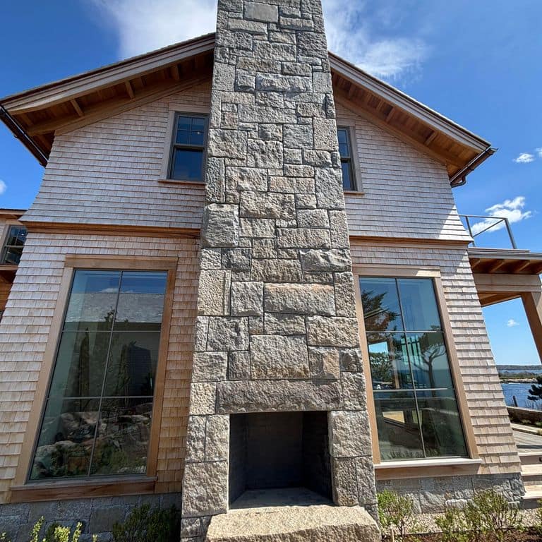 Application image for Reclaimed Granite Curbstone - Full Bed Veneer. The image shows this product being used in a full bed veneer application. The surface finish shown is . The dominant color shown is gray.