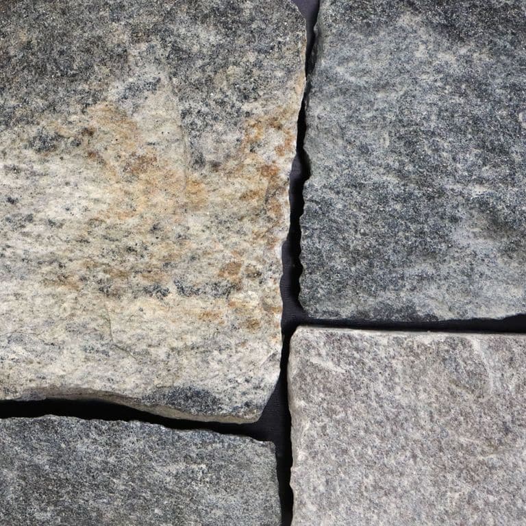 Best close-up image for Castleton Granite - Veneer - Seam/Bed Splitface. The image shows this product being used for full bed veneer and thin veneer. The surface finish shown is . The dominant color shown is gray. The color mix creates a warm feeling. Regular and blotched color patterns.